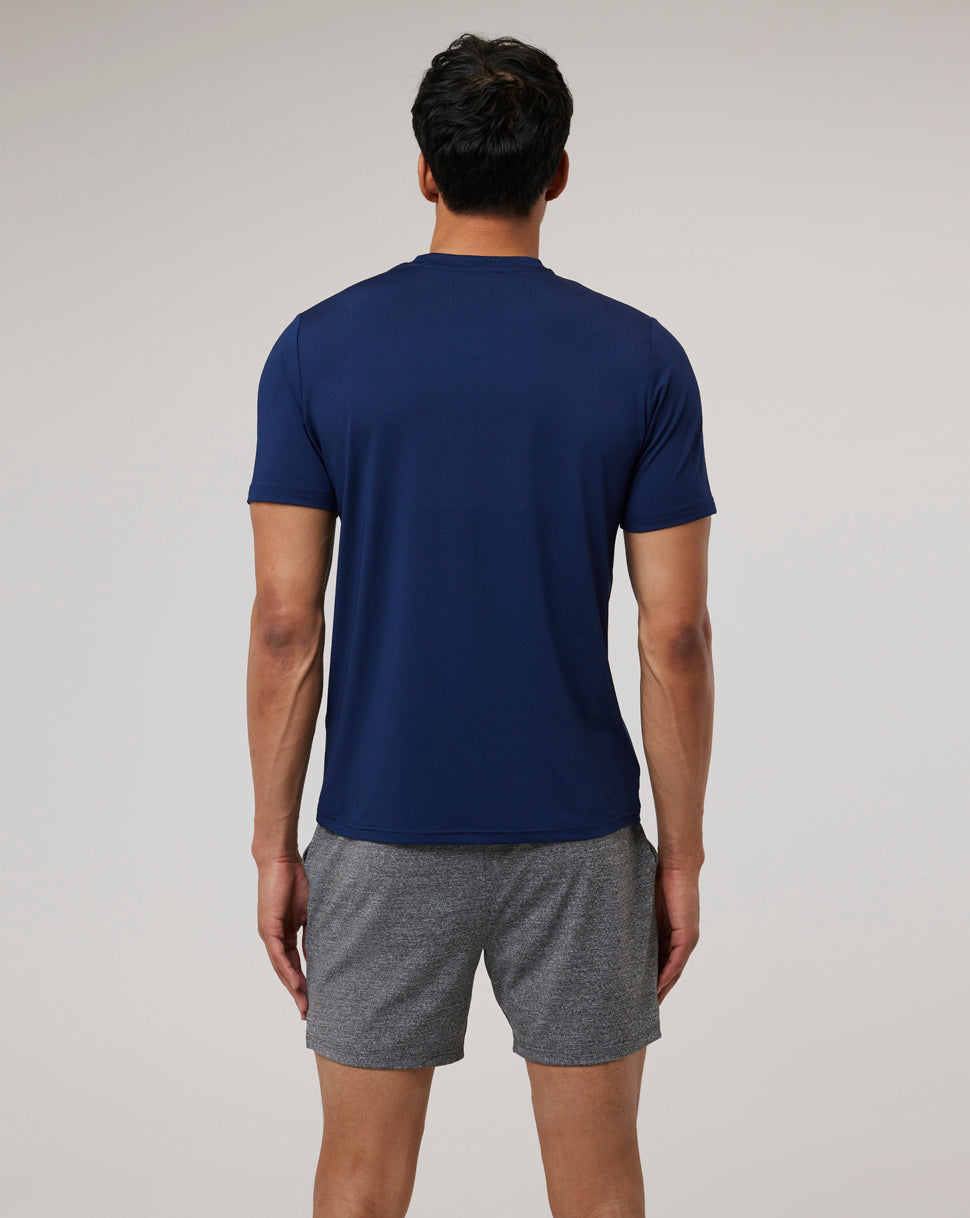 Back view of a model in navy Peacoat Active 365 Tee paired with grey shorts.