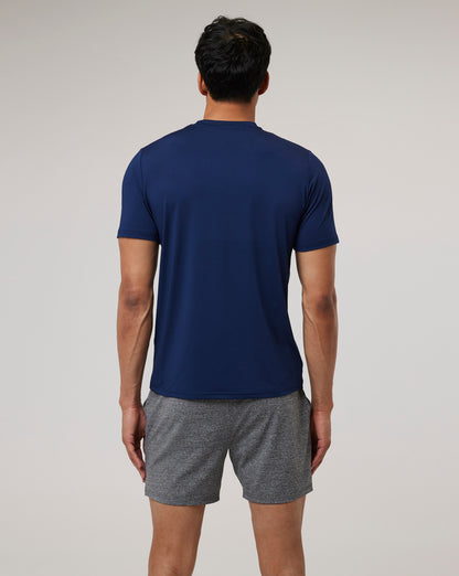 Back view of a model in navy Peacoat Active 365 Tee paired with grey shorts.