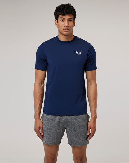 Model wearing navy Peacoat Active 365 Tee with reflective Castore Wings emblem on the chest.