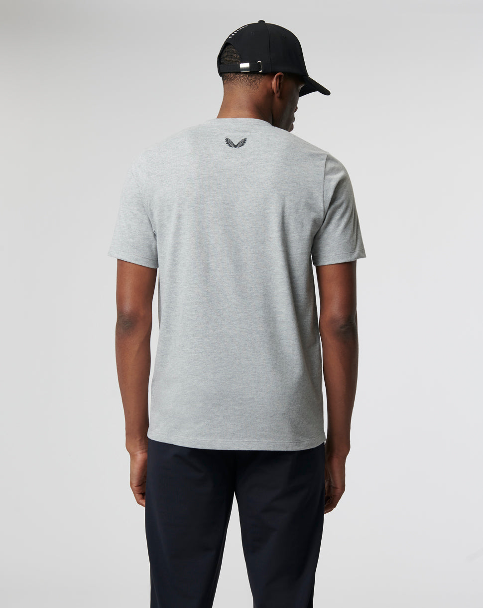 Back view of a Sharkskin Marl Carbon Capsule Recovery T Shirt in light grey with a small wing emblem on the upper back