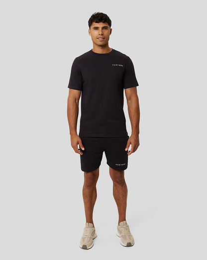 Full-length front view of a male model in black Onyx Carbon Capsule Recovery T-Shirt and matching shorts with CASTORE branding
