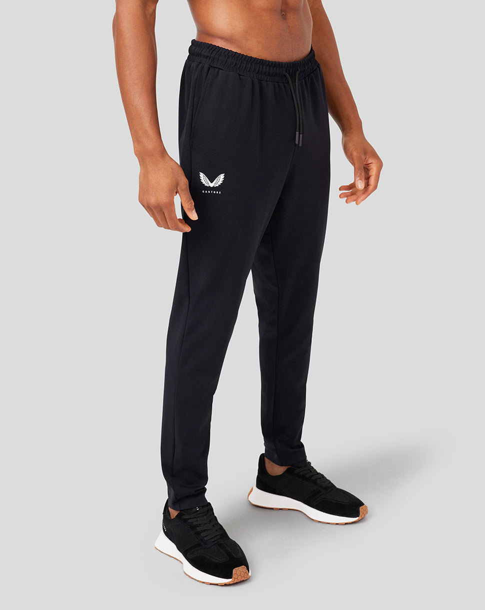 Man wearing black Onyx Active Slim Fit joggers with elastic waist and drawcord, side pockets and tapered legs.