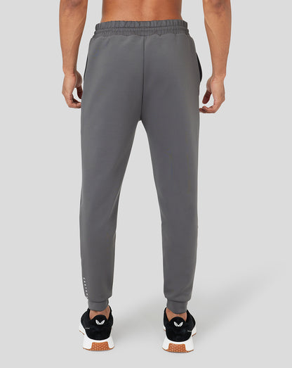 Back view of gray Ore Capsule scuba jogger with elastic waistband on a model.