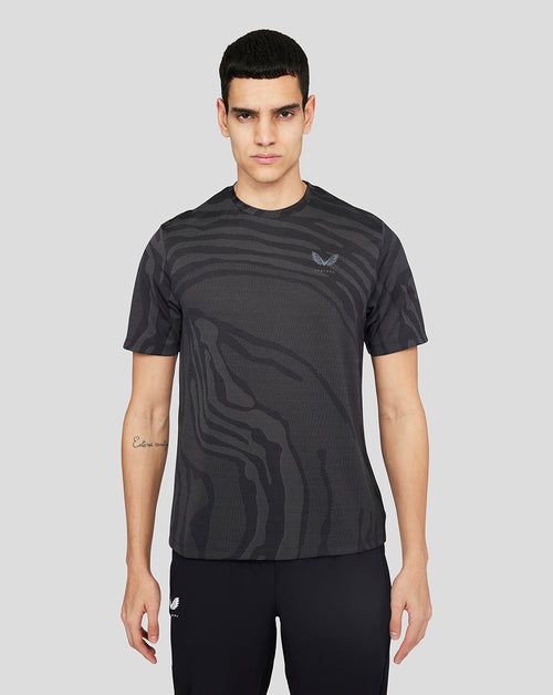 Male model in black Core Tech T shirt with textured pattern and small chest logo.
