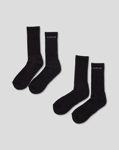 Two black Castore crew socks laid flat with ribbed cuffs for everyday wear.