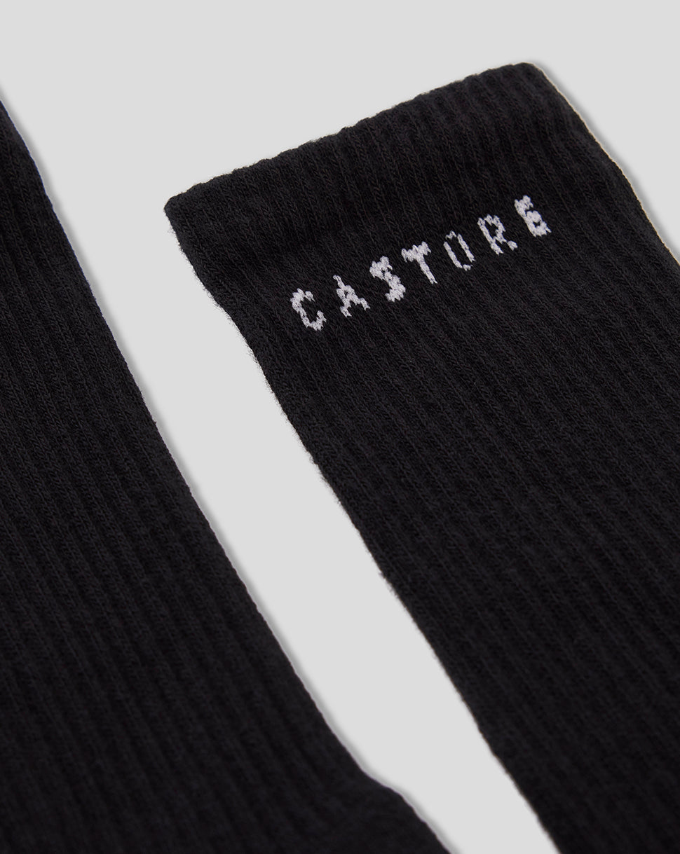Close up of black Castore crew sock from a 2 pack showing ribbed knit and white CASTORE branding