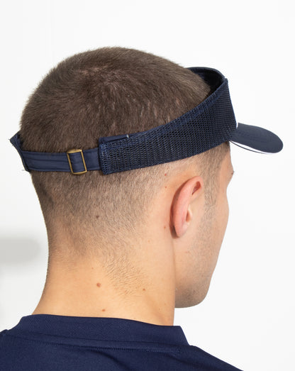 Side profile of a navy AMC Core visor worn by a person with an adjustable strap and curved brim.
