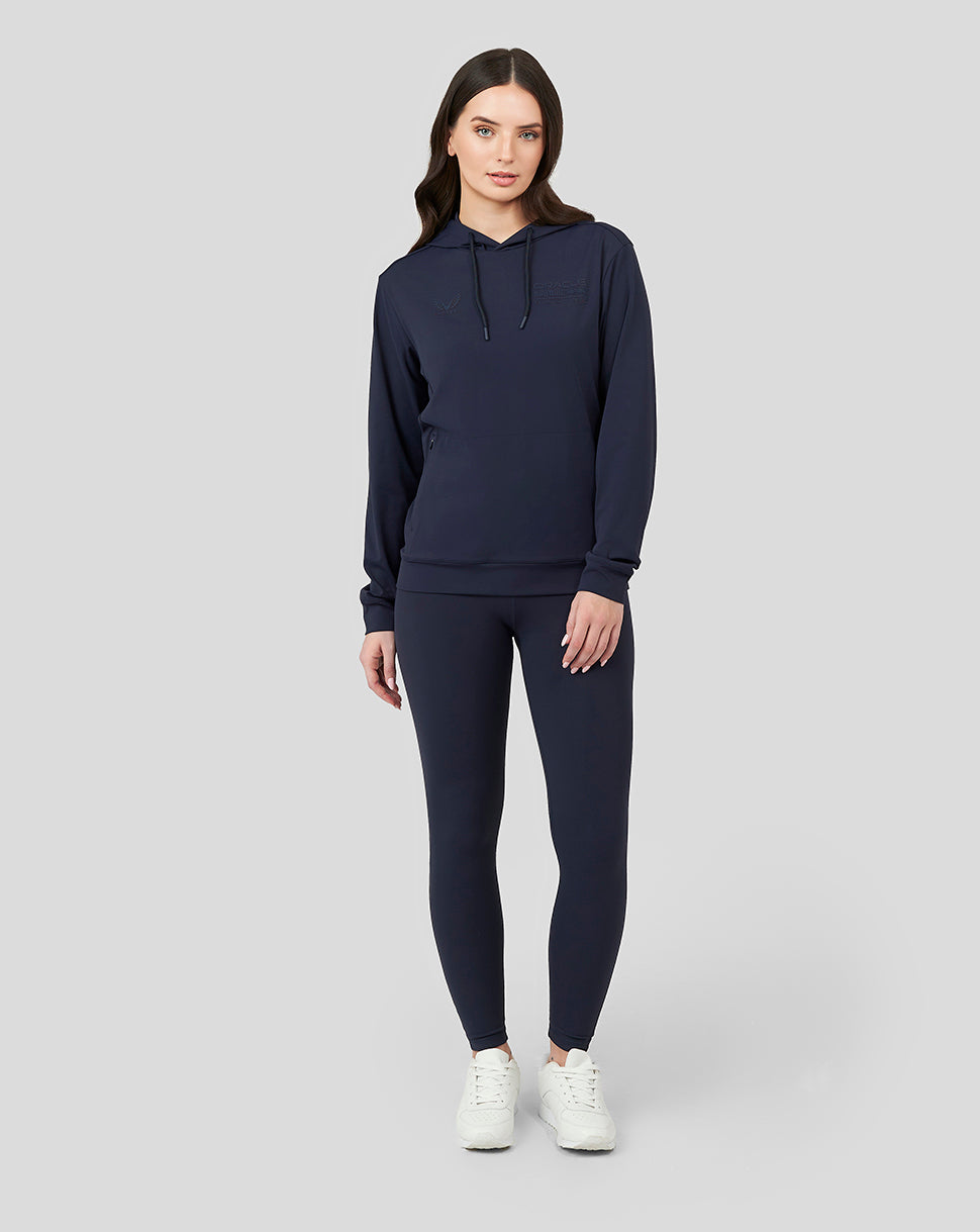 Front view of a woman wearing a Night Sky navy Oracle Red Bull Racing women's overhead hoodie with chest logos