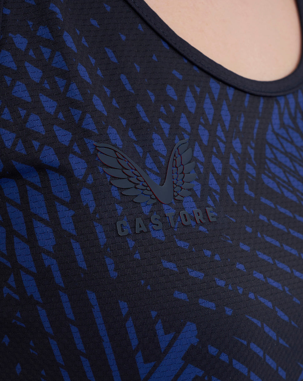 Close-up of navy night sky tank top fabric with a wing Castore logo on the chest