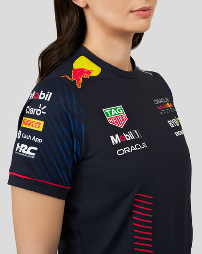 Side close up of navy racing jersey showing a yellow Red Bull emblem near the neck and multiple sponsor decals