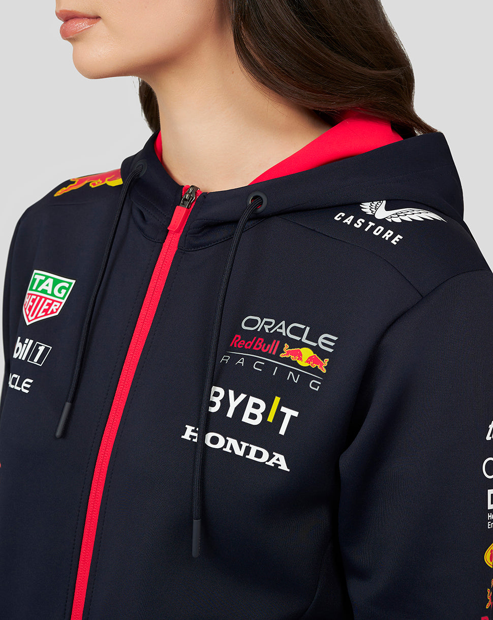 Close up of navy night sky hoodie with bright pink zipper and sponsor logos on the chest