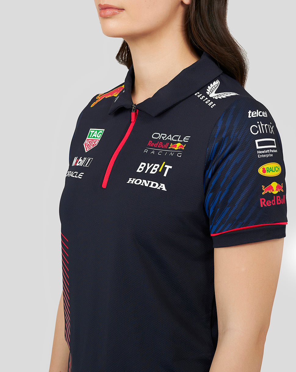 Close up of navy polo with collar and red zipper, chest logos for Oracle Red Bull Racing and sponsors.