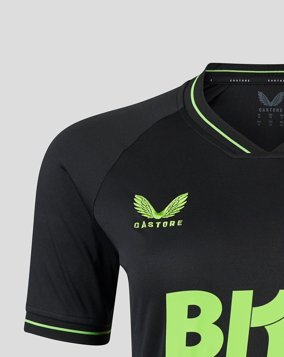 Close-up of the lime green Castore logo and neon graphic on the chest of the black goalkeeper shirt.