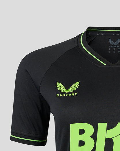 Close-up of the lime green Castore logo and neon graphic on the chest of the black goalkeeper shirt.