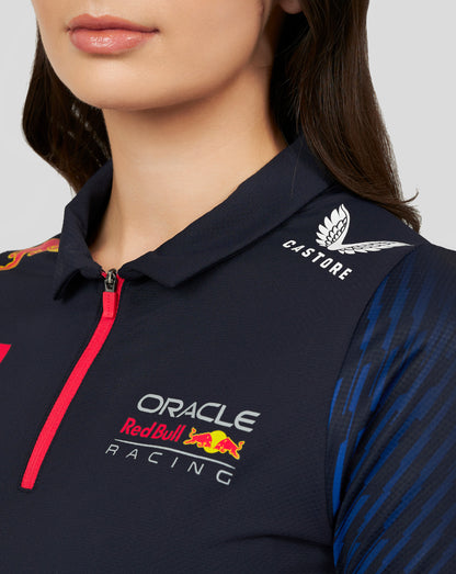 Close-up of a navy Oracle Red Bull Racing women's polo with a pink zipper, featuring Castore logo and Oracle Red Bull Racing branding