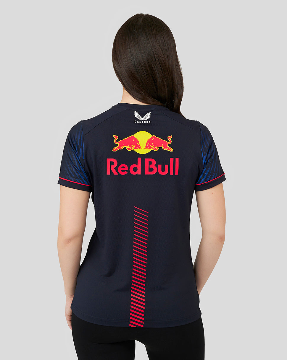 Back view of a woman in a navy Red Bull Racing T shirt with a large Red Bull logo on the back.