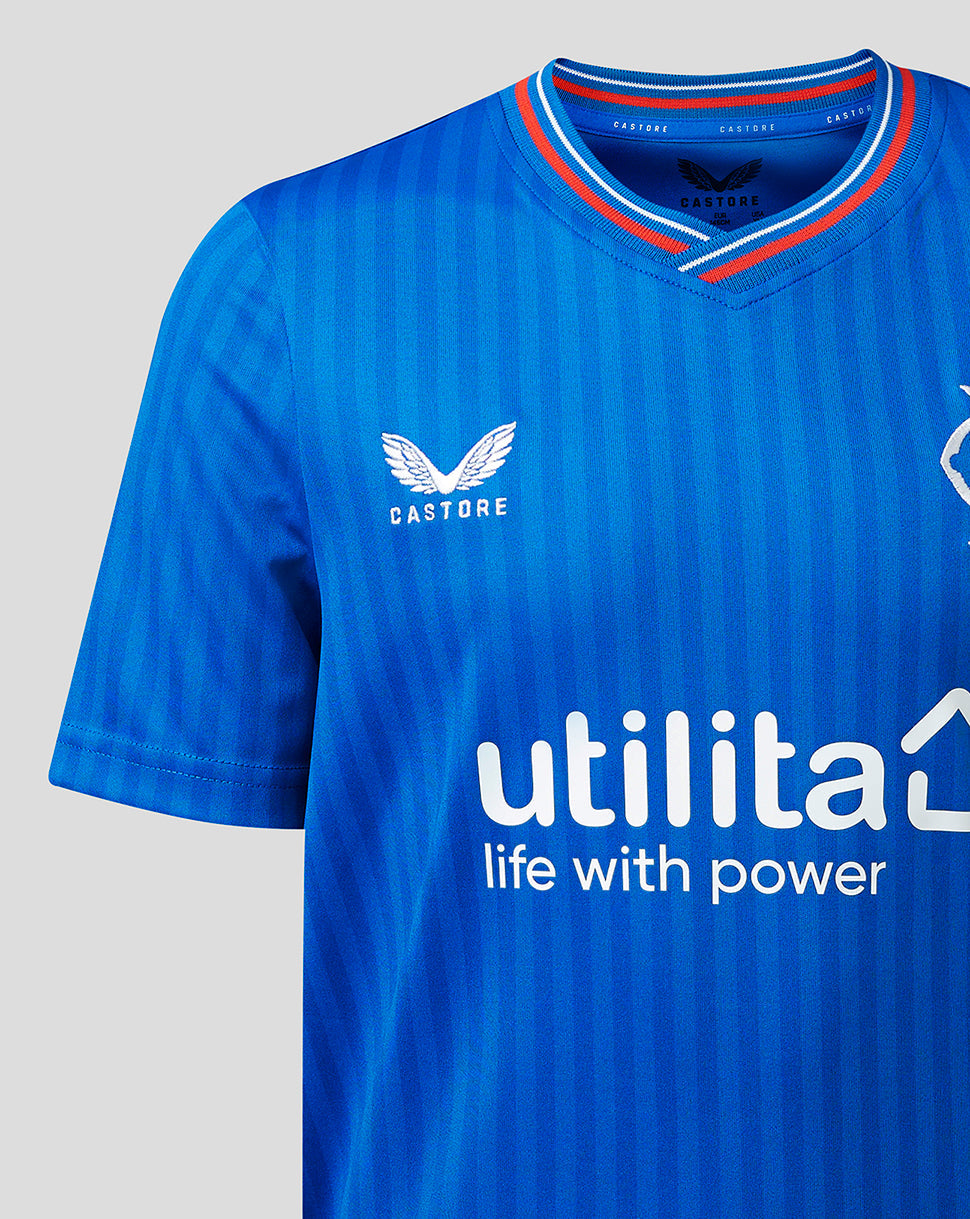 Close-up of blue Rangers Junior 23/24 Home Shirt front with striped V-neck, crest on the chest, and Utilita sponsor