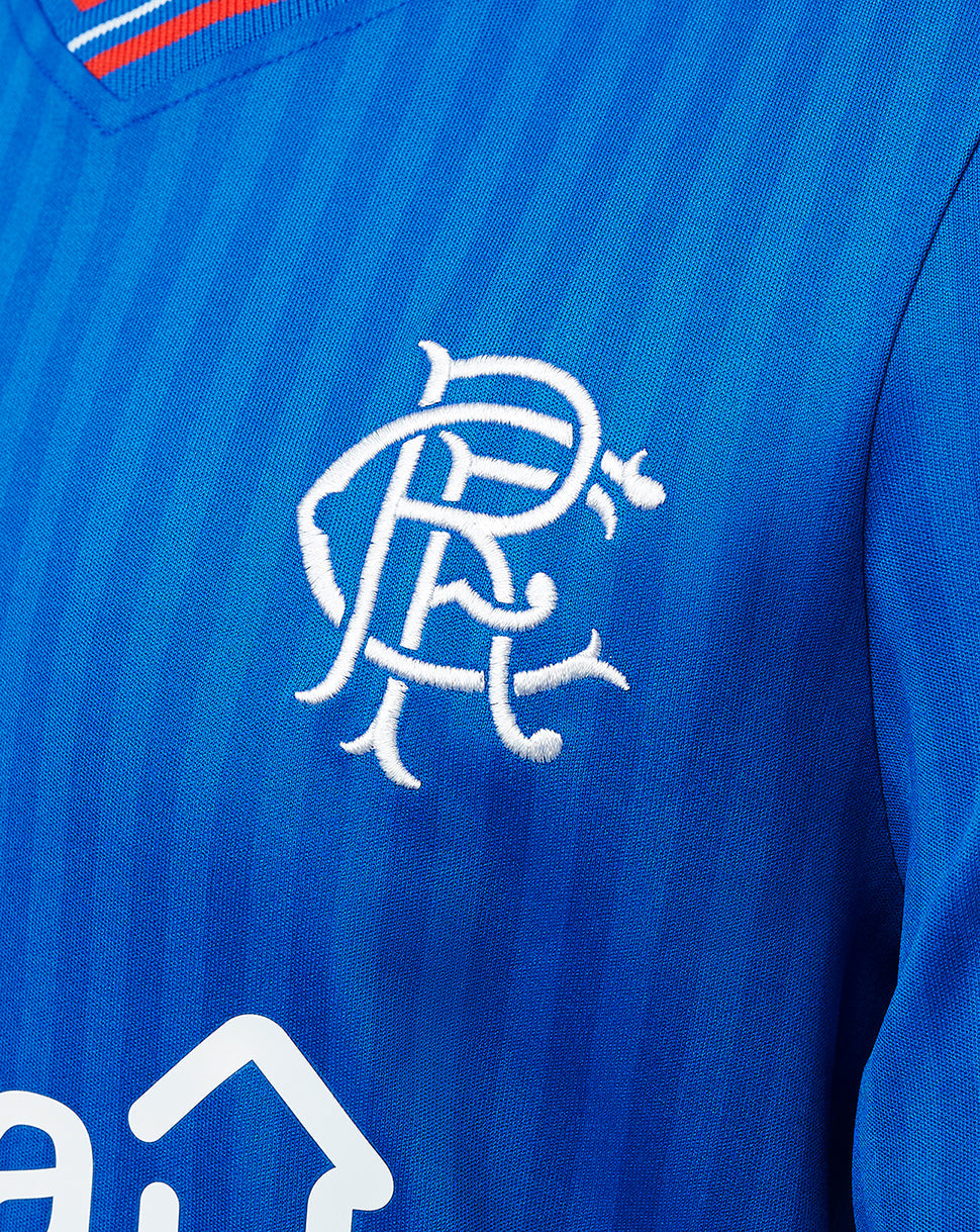 Close-up of blue Rangers Junior 23/24 home shirt showing white embroidered club crest on chest.