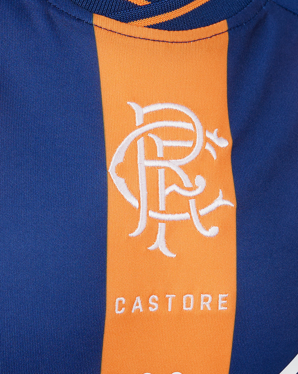 Close-up of white crest on orange stripe of Rangers Junior 23/24 Third Shirt