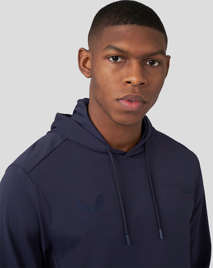Portrait of a male model wearing a navy Oracle Red Bull Racing overhead hoodie with chest logos.