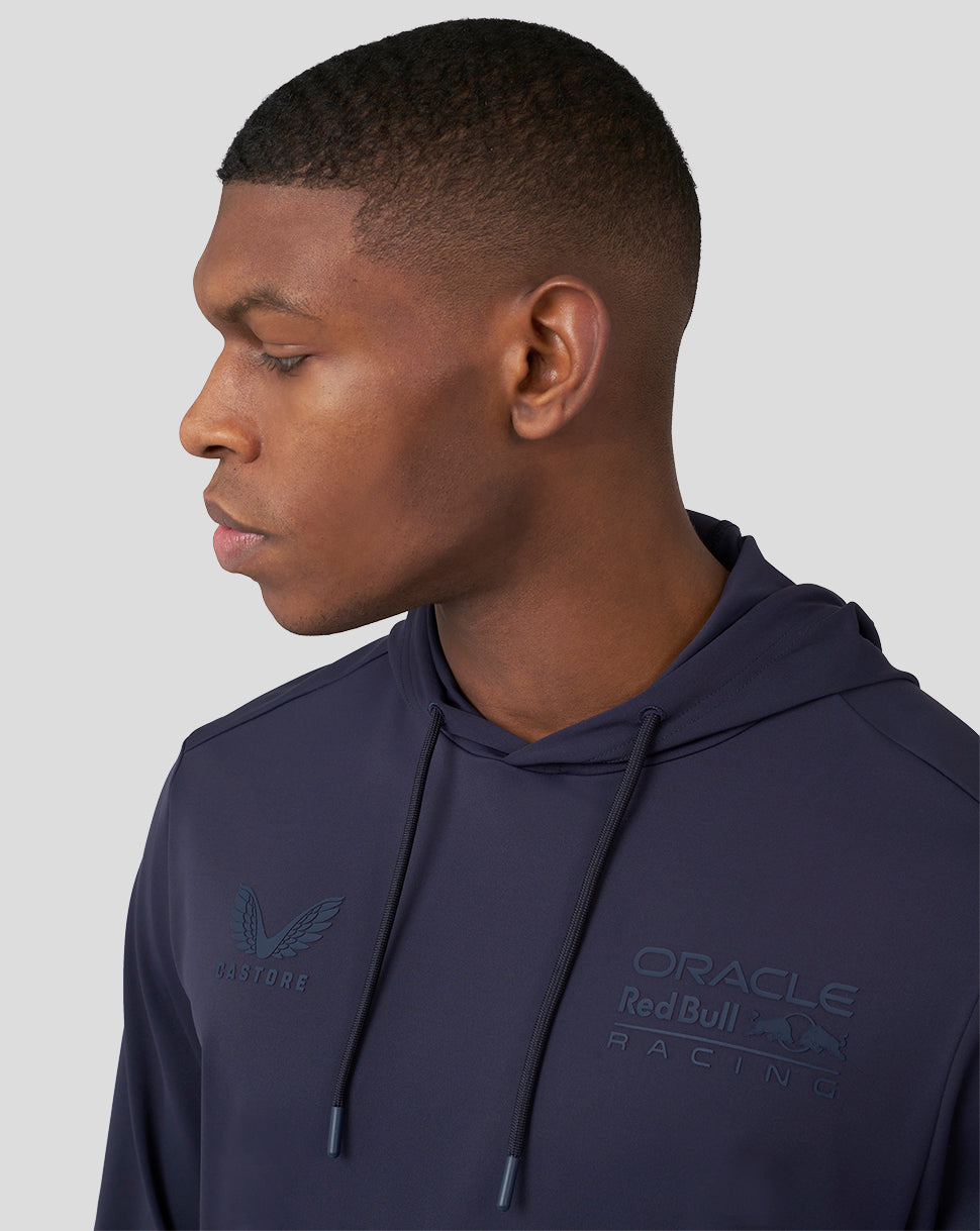 Side profile of a male model wearing a navy Oracle Red Bull Racing overhead hoodie with chest logo visible.