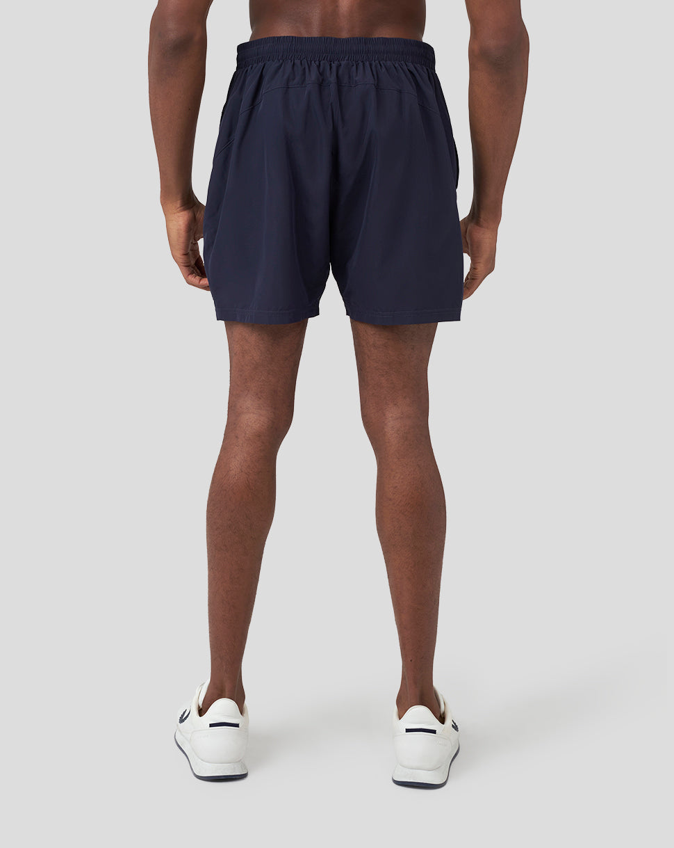 Back view of navy Oracle Red Bull Racing running shorts on a male model.