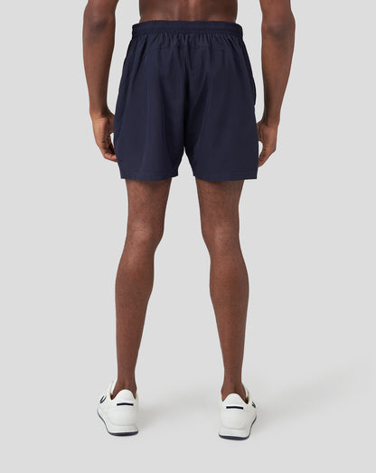 Back view of navy Oracle Red Bull Racing running shorts on a male model.