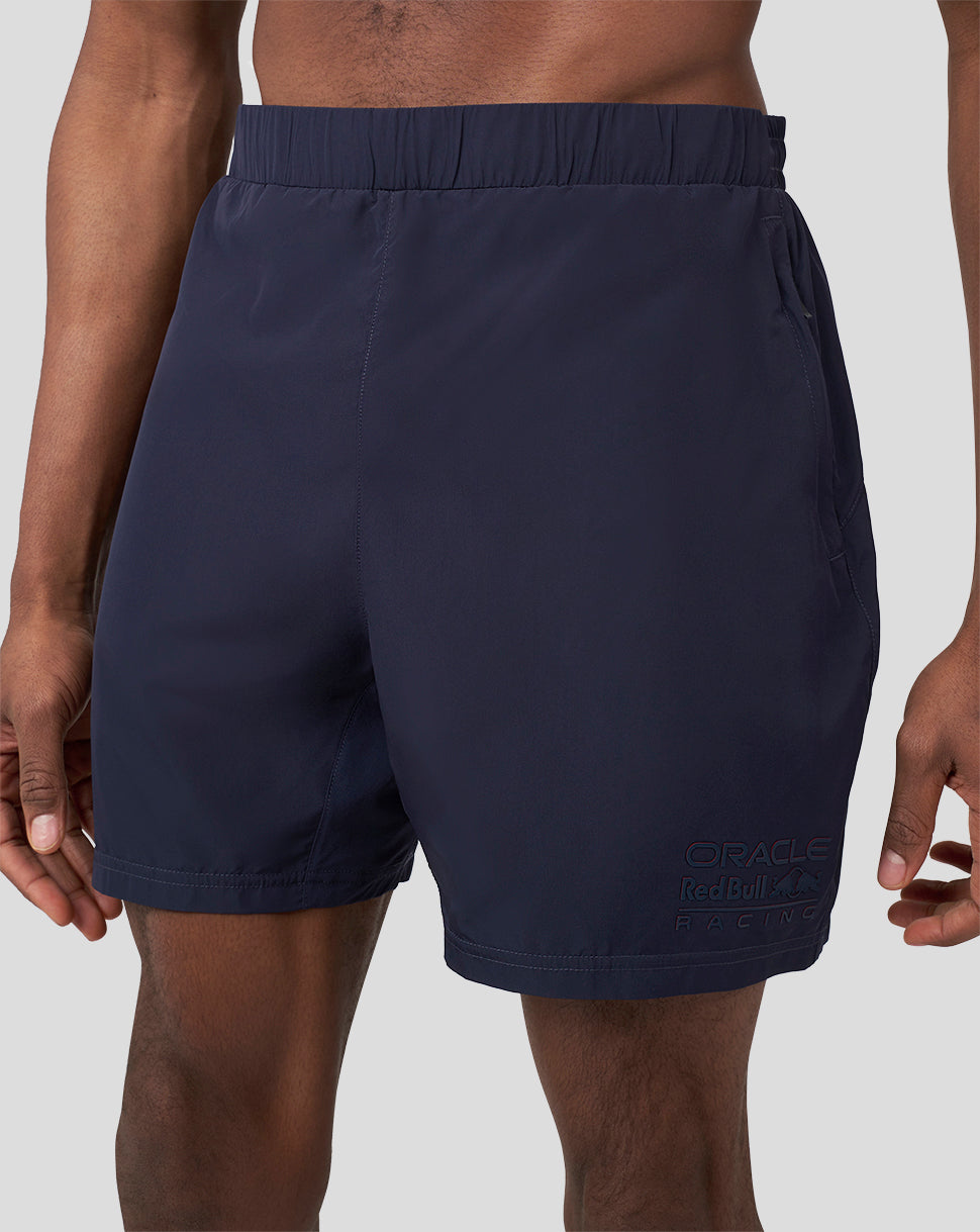 Close up of navy shorts with Oracle Red Bull Racing logo near the hem.