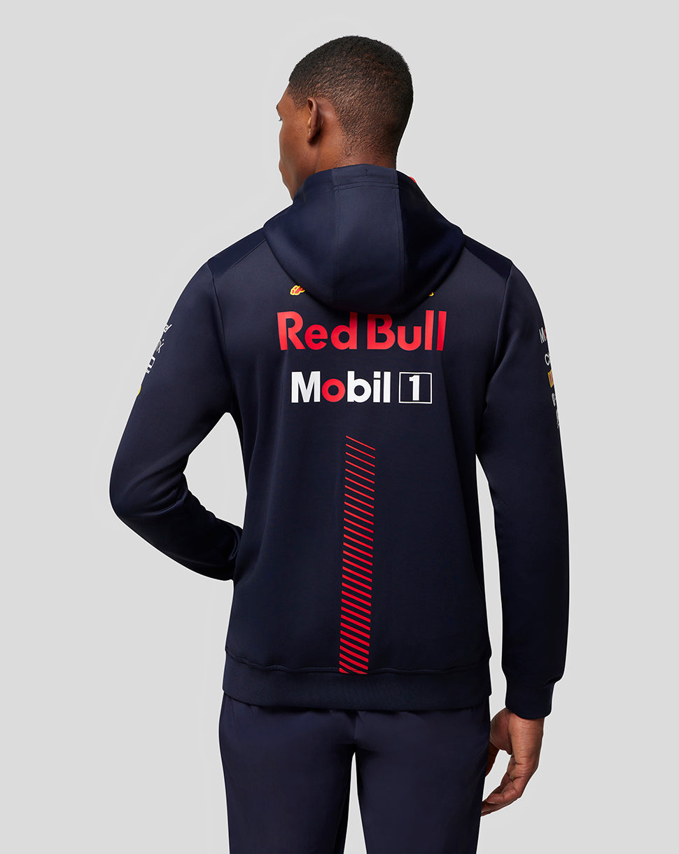 Back view of a man wearing a navy Oracle Red Bull Racing hoodie with Red Bull and Mobil 1 logos and a red diagonal stripe down the back.