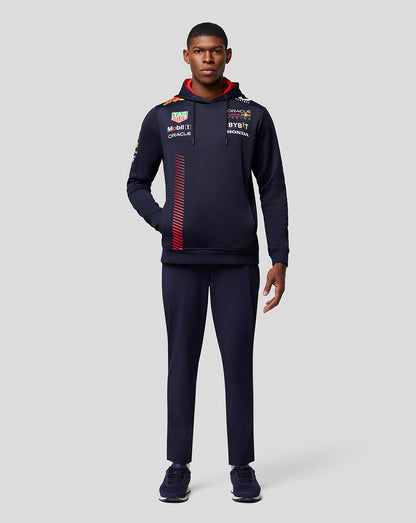 Full-body shot of model in navy Oracle Red Bull Racing hoodie with matching pants and sneakers.