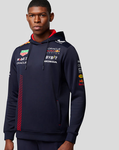 Navy Oracle Red Bull Racing hoodie worn by a male model showcasing sponsor logos and a front pocket.