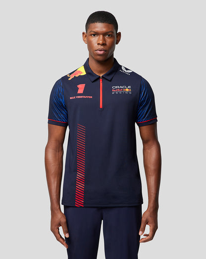 Front view of a male model wearing a navy Oracle Red Bull Racing polo with Verstappen branding and sponsor logos.