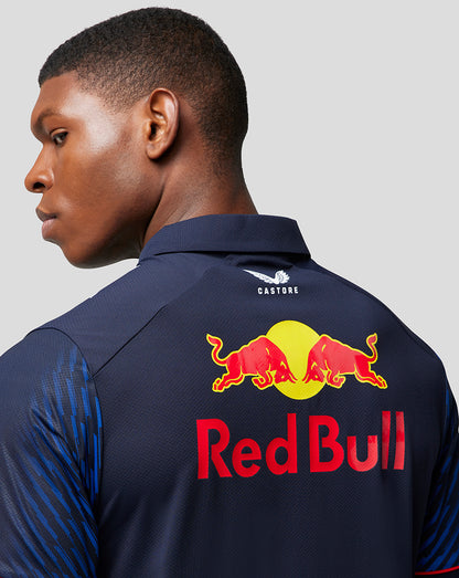Back view of navy Red Bull Racing polo with large Red Bull logo on the back and Castore branding at the collar.