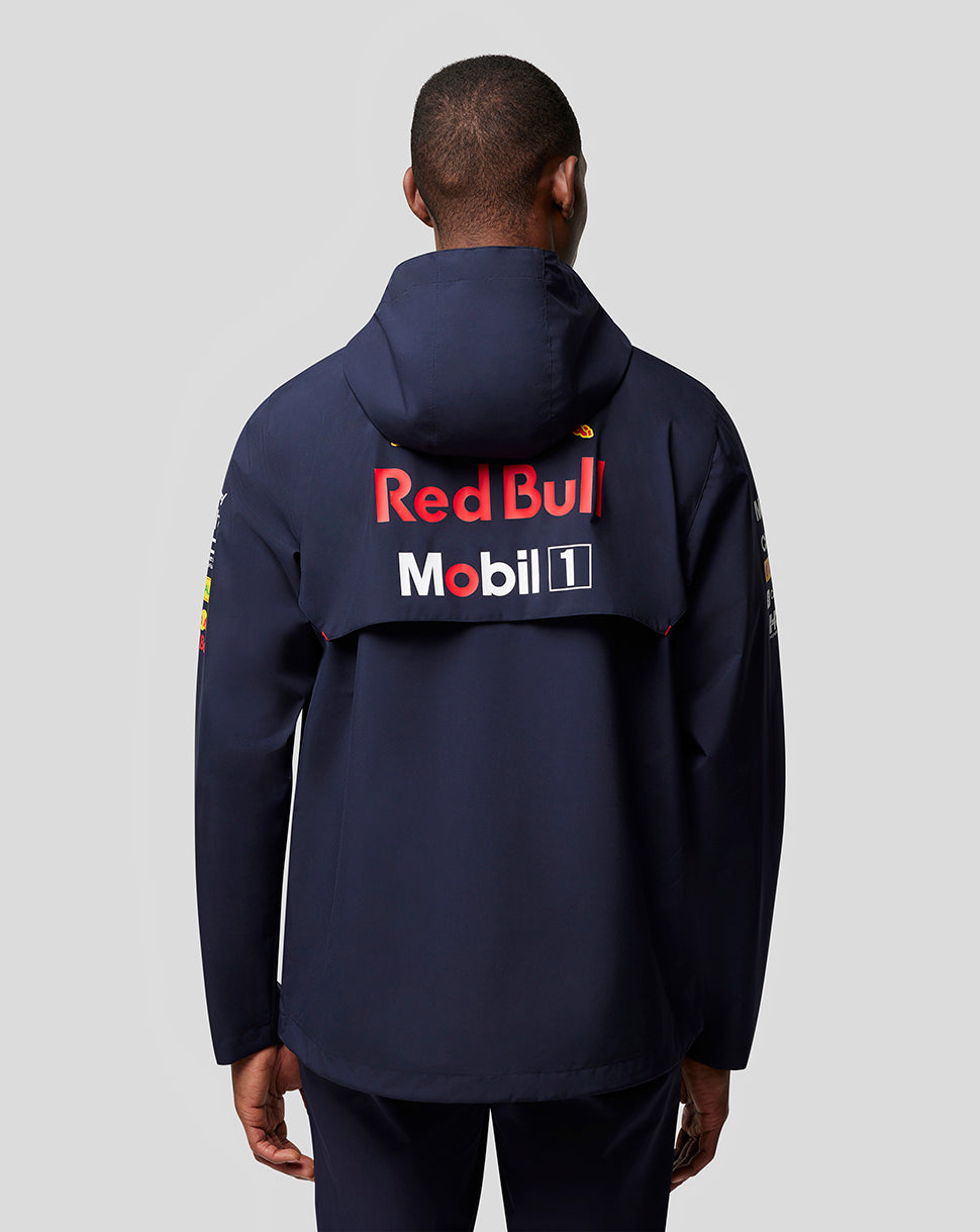 Back view of a model in navy Red Bull Racing jacket with large Red Bull and Mobil 1 logos across the upper back