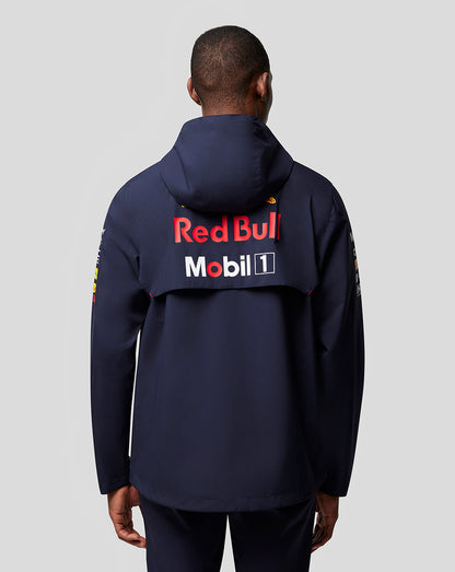 Back view of a model in navy Red Bull Racing jacket with large Red Bull and Mobil 1 logos across the upper back