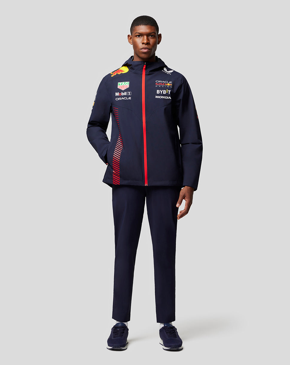Male model wearing Oracle Red Bull Racing water resistant navy jacket with red front zipper and sponsor logos.