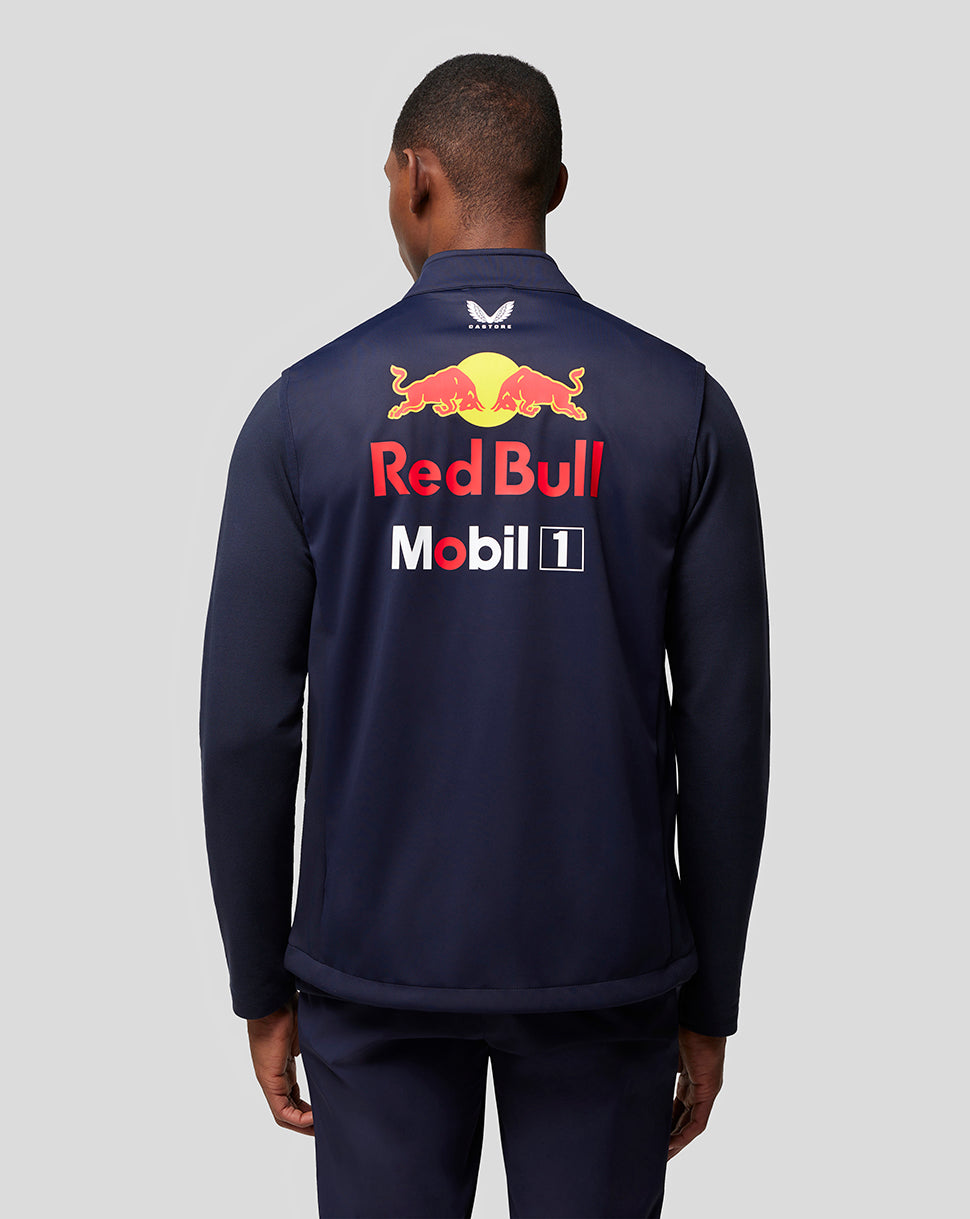 Back view of a man in a navy Red Bull Racing jacket with large Red Bull Mobil 1 logos