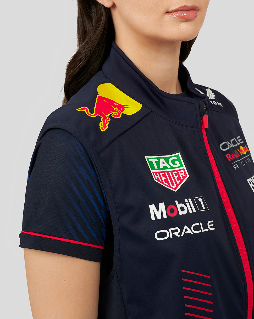 Close-up of navy gilet chest with Red Bull crest and sponsor logos including Oracle Mobil 1 TAG Heuer.