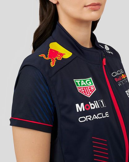 Close-up of navy gilet chest with Red Bull crest and sponsor logos including Oracle Mobil 1 TAG Heuer.