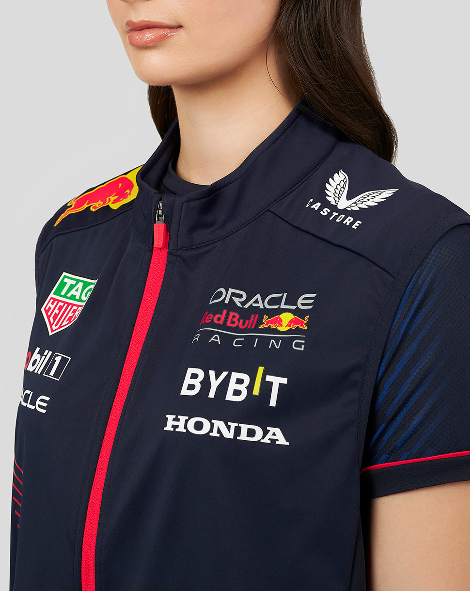 Close-up of the navy gilet front with red zipper and sponsor logos including Red Bull Mobil 1 Oracle BYBIT Honda and TAG Heuer.