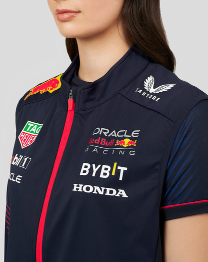 Close-up of the navy gilet front with red zipper and sponsor logos including Red Bull Mobil 1 Oracle BYBIT Honda and TAG Heuer.