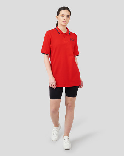 Female model wearing flame scarlet Oracle Red Bull Racing Core Polo with navy tipped collar and cuffs