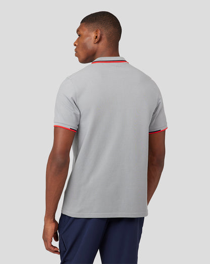 Back view of a man wearing a grey Oracle Red Bull Racing Core Polo with red trim on collar and sleeves.