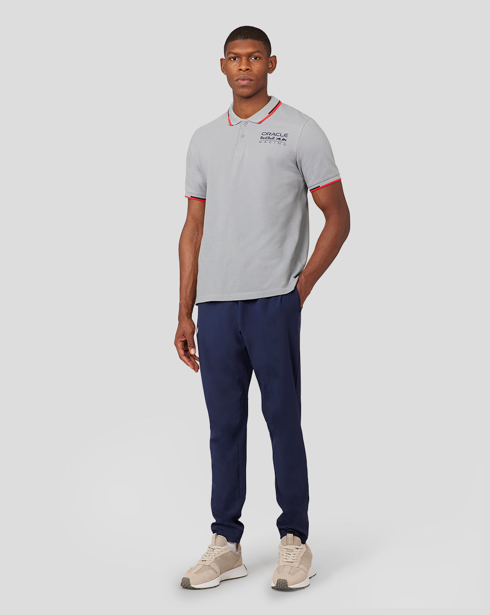 Male model wearing a grey Oracle Red Bull Racing polo with red piping and a chest logo.