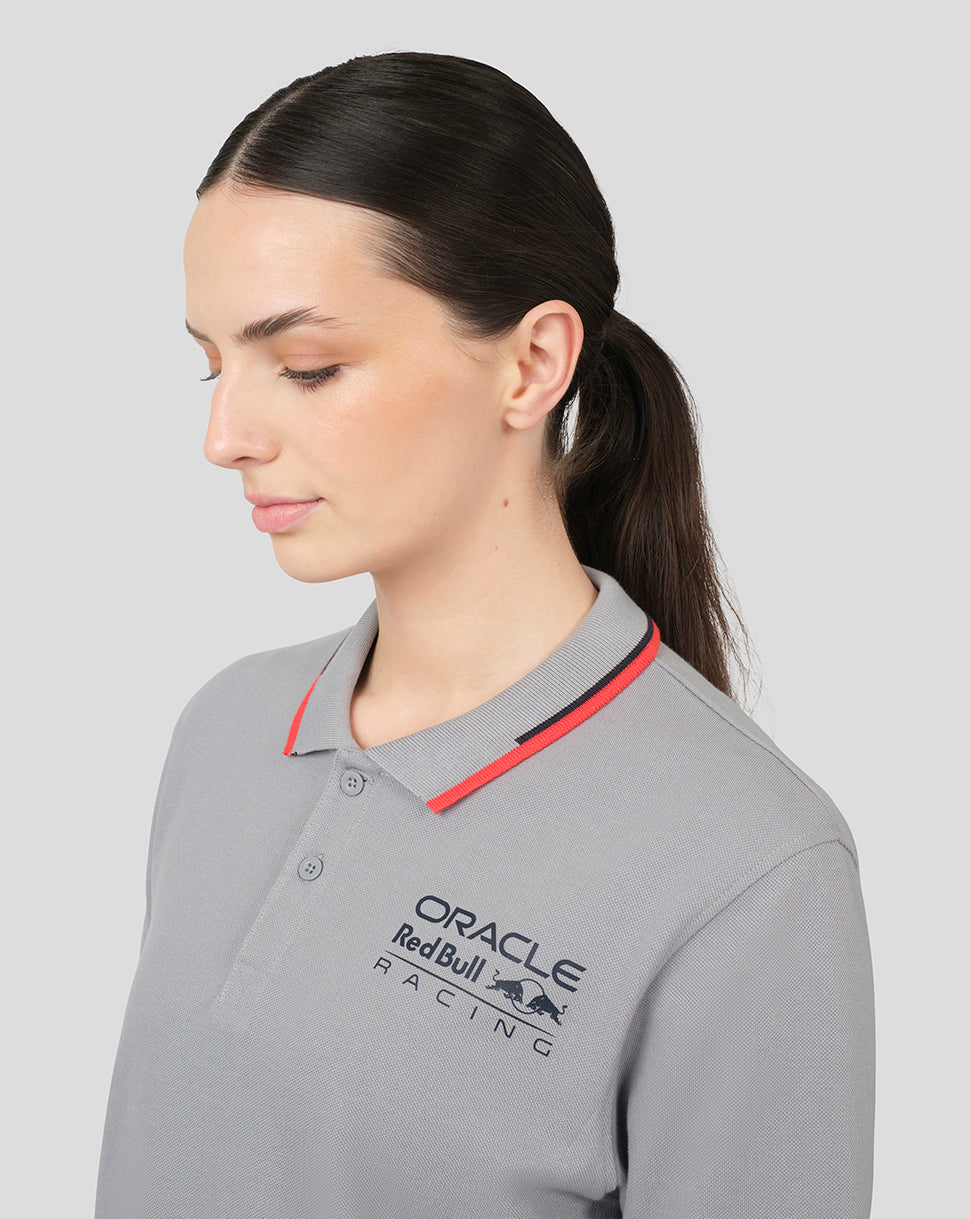 Portrait of a woman wearing a grey Oracle Red Bull Racing polo with red piping on the collar.