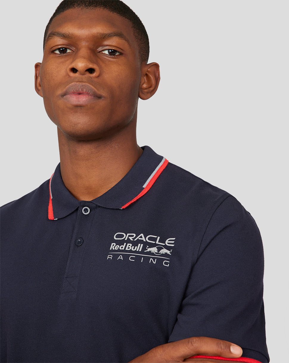 Close up of navy Night Sky Oracle Red Bull Racing Core Polo showing logo on the chest and red tipped collar.