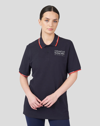 Model wearing navy Oracle Red Bull Racing Core Polo with red piping on collar and sleeve cuffs and chest logo