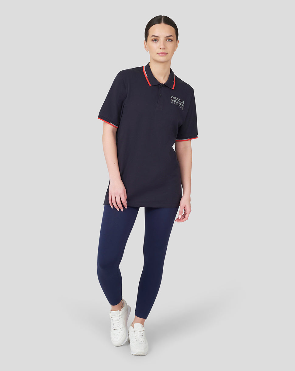 Model wearing Oracle Red Bull Racing Core Polo in Night Sky navy with red trim and chest logo