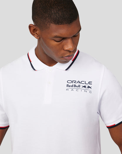 White Oracle Red Bull Racing polo with chest logo and navy red tipped collar worn by a model.