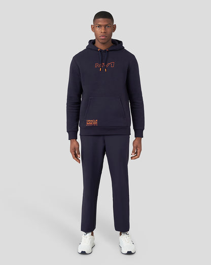 Full model wearing navy hoodie with orange chest logo and drawstring hood